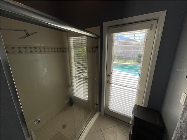 bathroom featuring tile patterned floors and a shower with shower door