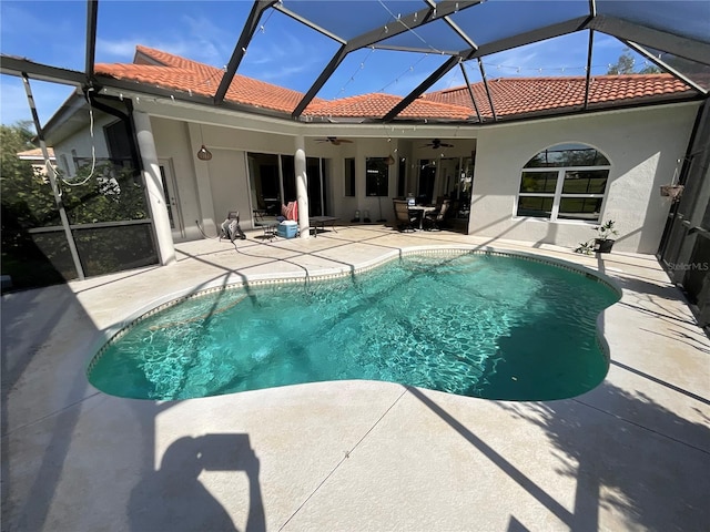 view of pool with a lanai, a patio area, and ceiling fan