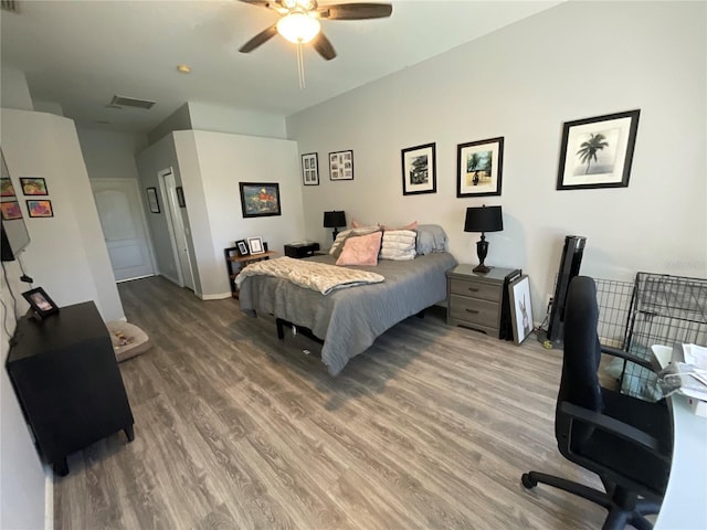 bedroom with ceiling fan and hardwood / wood-style flooring