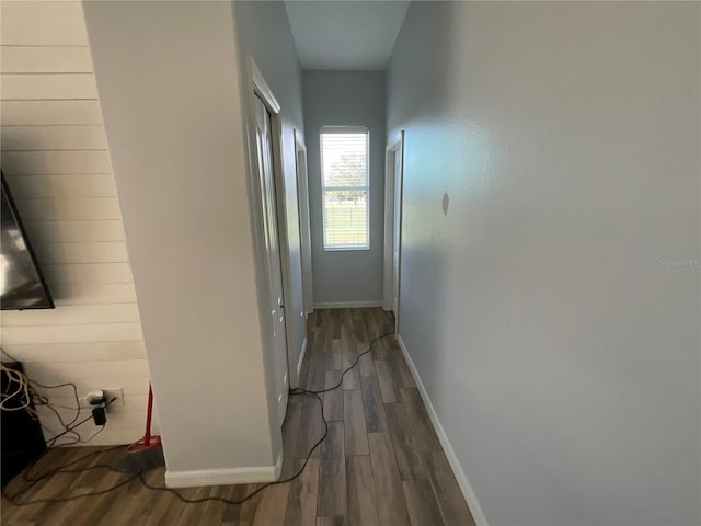 corridor with hardwood / wood-style flooring