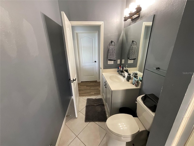 bathroom featuring toilet, vanity, and tile patterned floors