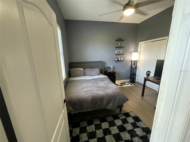 bedroom with hardwood / wood-style floors, ceiling fan, and a closet