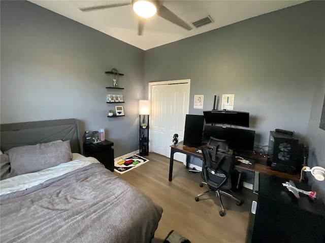 bedroom featuring ceiling fan, a closet, and hardwood / wood-style floors