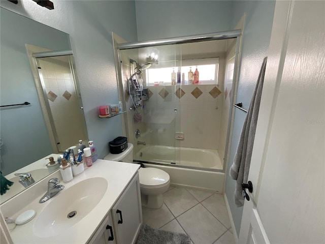 full bathroom with toilet, vanity, tile patterned floors, and enclosed tub / shower combo