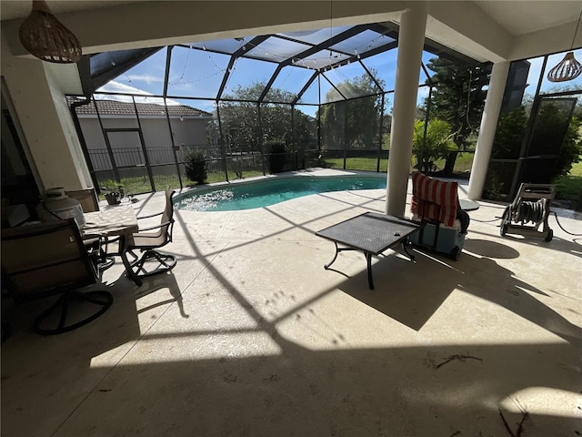 view of pool with a patio and glass enclosure