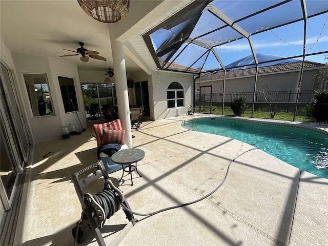 view of swimming pool featuring a patio area, ceiling fan, and a lanai