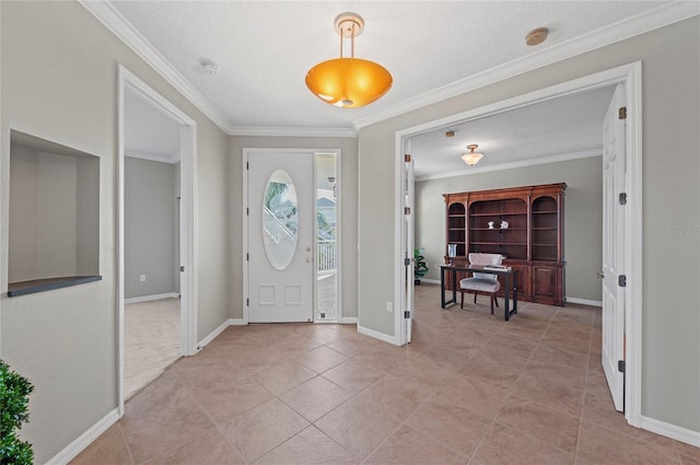 entrance foyer featuring light tile patterned floors, a textured ceiling, and ornamental molding