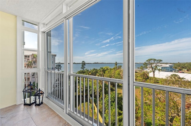 sunroom / solarium featuring a water view