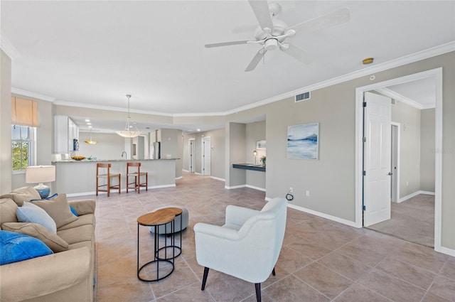 living room with ceiling fan, light tile patterned flooring, and ornamental molding