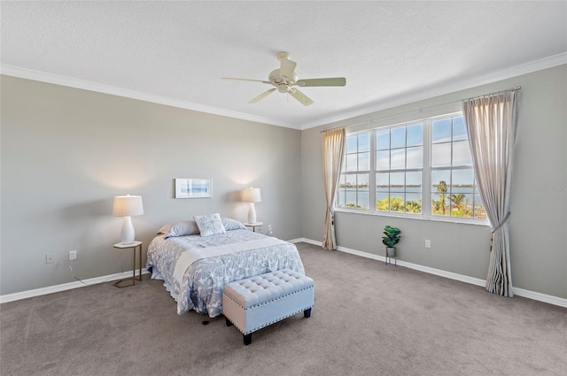 bedroom with ceiling fan, carpet, a textured ceiling, and ornamental molding