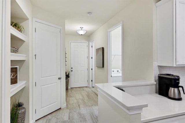 hallway with light hardwood / wood-style floors