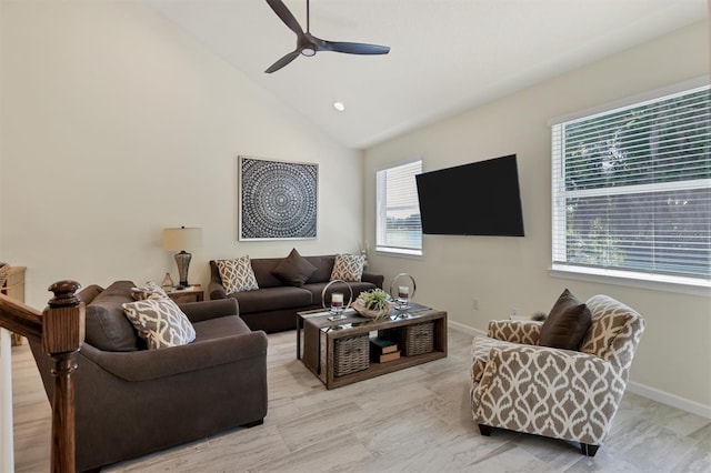 living room featuring ceiling fan and lofted ceiling