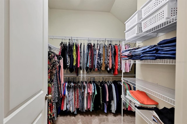 spacious closet with vaulted ceiling and carpet