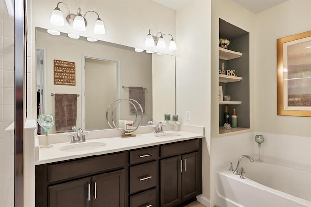 bathroom with a tub, built in features, and vanity