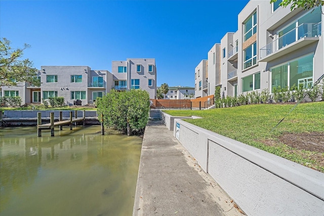 surrounding community featuring a yard and a water view