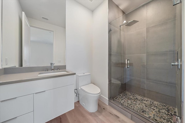 bathroom with hardwood / wood-style floors, vanity, toilet, and an enclosed shower