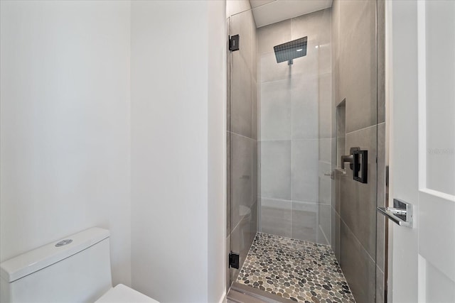 bathroom with walk in shower and toilet