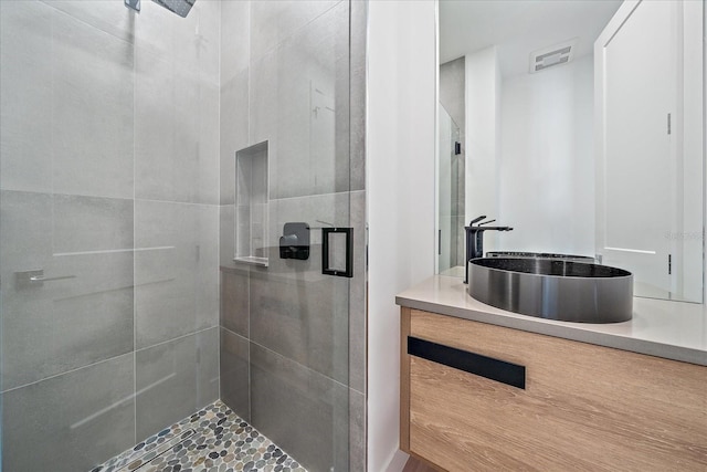 bathroom with vanity and a shower with door