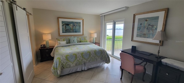 bedroom with a barn door, access to outside, and light tile patterned flooring