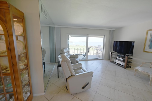 living room featuring light tile patterned floors, baseboards, and visible vents