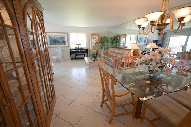 dining room featuring a healthy amount of sunlight, a notable chandelier, and light tile patterned floors