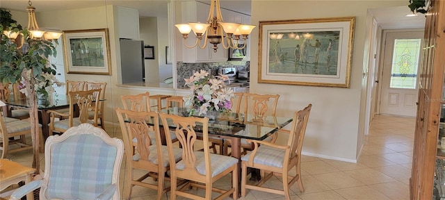 dining room with light tile patterned floors, baseboards, and a notable chandelier