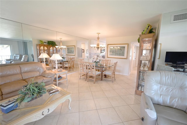 living room with light tile patterned flooring, visible vents, and an inviting chandelier