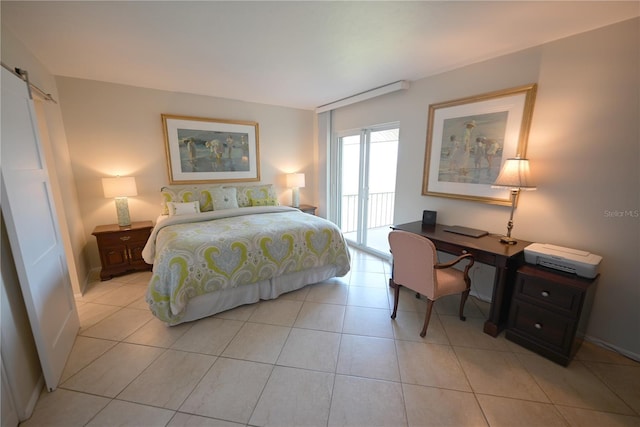 bedroom featuring access to outside, light tile patterned flooring, and a barn door