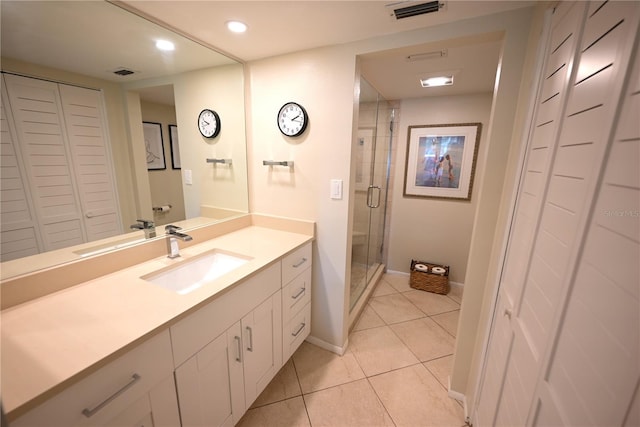 full bath featuring a closet, vanity, visible vents, and tile patterned floors