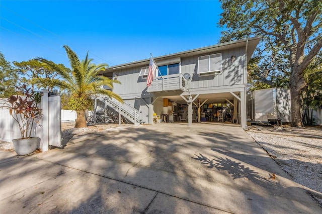 3511 Camino Real, Sarasota, FL 34239 - view of front facade with a carport, stairway, and concrete driveway