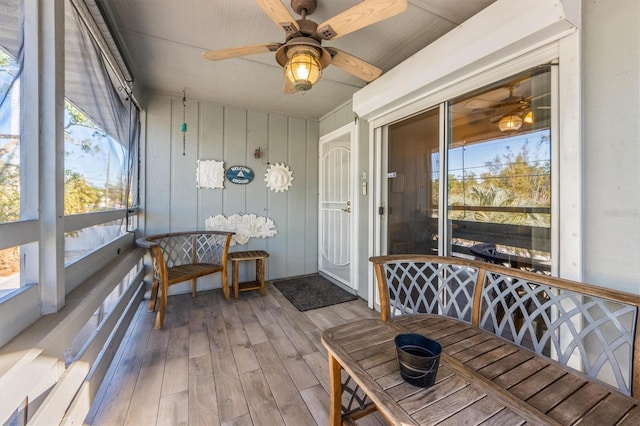 sunroom with baseboard heating, ceiling fan, and a healthy amount of sunlight