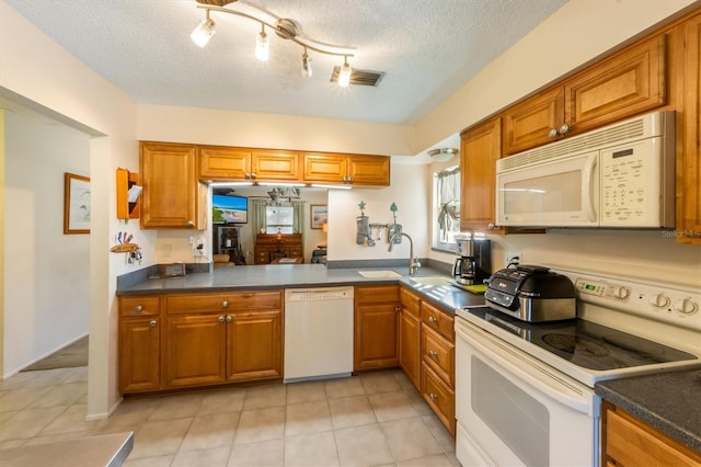 3511 Camino Real, Sarasota, FL 34239 - kitchen featuring white appliances, a sink, brown cabinets, dark countertops, and a textured ceiling