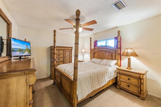 bedroom featuring ceiling fan, carpet, and a textured ceiling