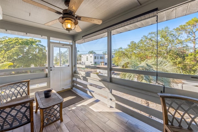 sunroom featuring ceiling fan