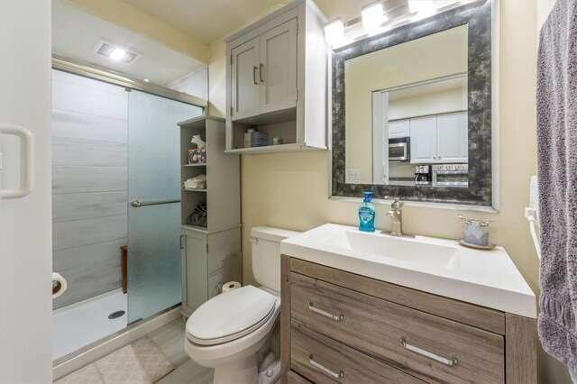 3511 Camino Real, Sarasota, FL 34239 - bathroom featuring vanity, a shower stall, toilet, and tile patterned flooring
