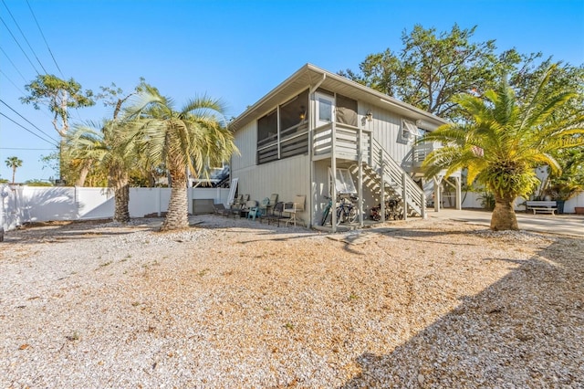 3511 Camino Real, Sarasota, FL 34239 - rear view of house featuring stairway and a sunroom