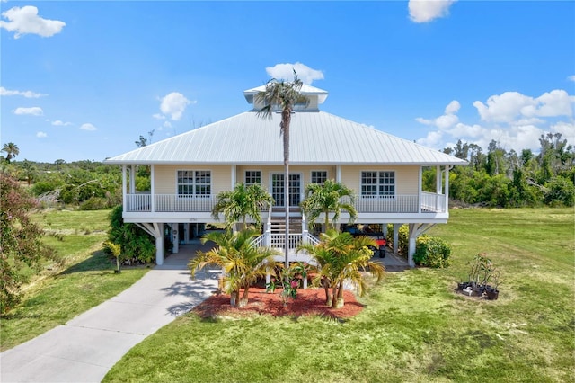 view of front facade with a porch, a carport, and a front lawn