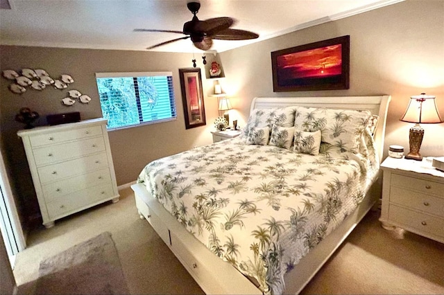 carpeted bedroom with ceiling fan and crown molding