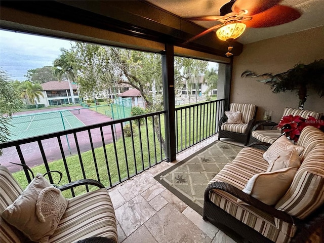 sunroom featuring ceiling fan and a healthy amount of sunlight