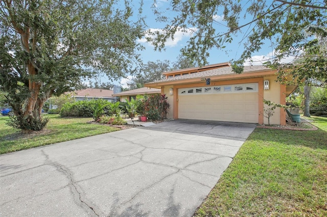 view of front of home with a front lawn and a garage