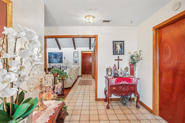 tiled entryway featuring a textured ceiling