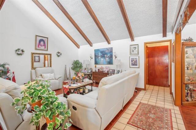 tiled living room with a textured ceiling and lofted ceiling with beams