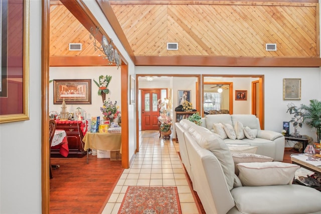 living room featuring light tile patterned floors, wood ceiling, and high vaulted ceiling