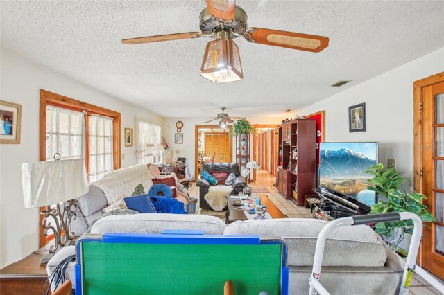 living room featuring light tile patterned floors and a textured ceiling