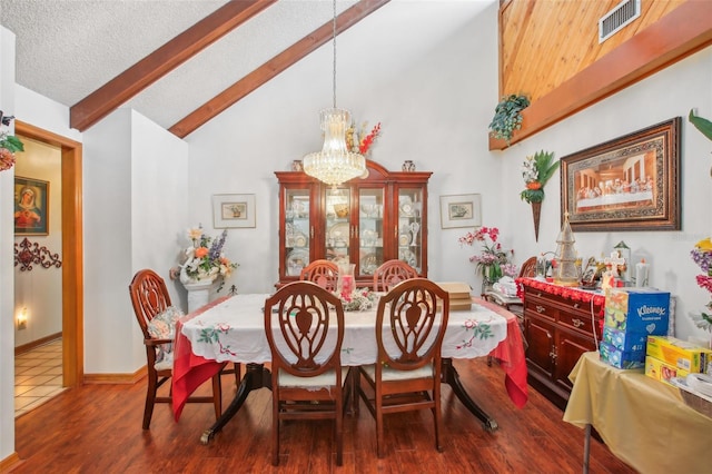 dining room featuring dark hardwood / wood-style flooring, a textured ceiling, high vaulted ceiling, beamed ceiling, and a chandelier