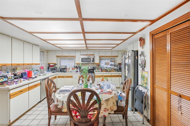 kitchen featuring white cabinetry, light tile patterned flooring, and stainless steel appliances