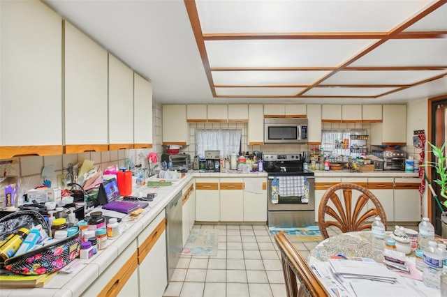 kitchen featuring light tile patterned floors and appliances with stainless steel finishes