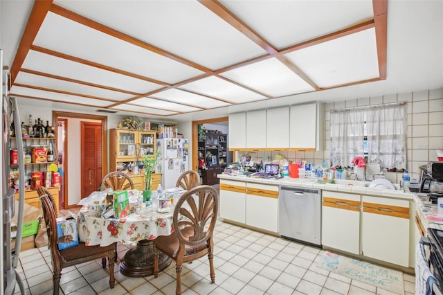 kitchen featuring dishwasher, white fridge, white cabinets, and range with electric stovetop