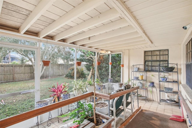 sunroom / solarium featuring beam ceiling