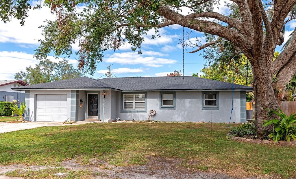 ranch-style home with a front yard and a garage